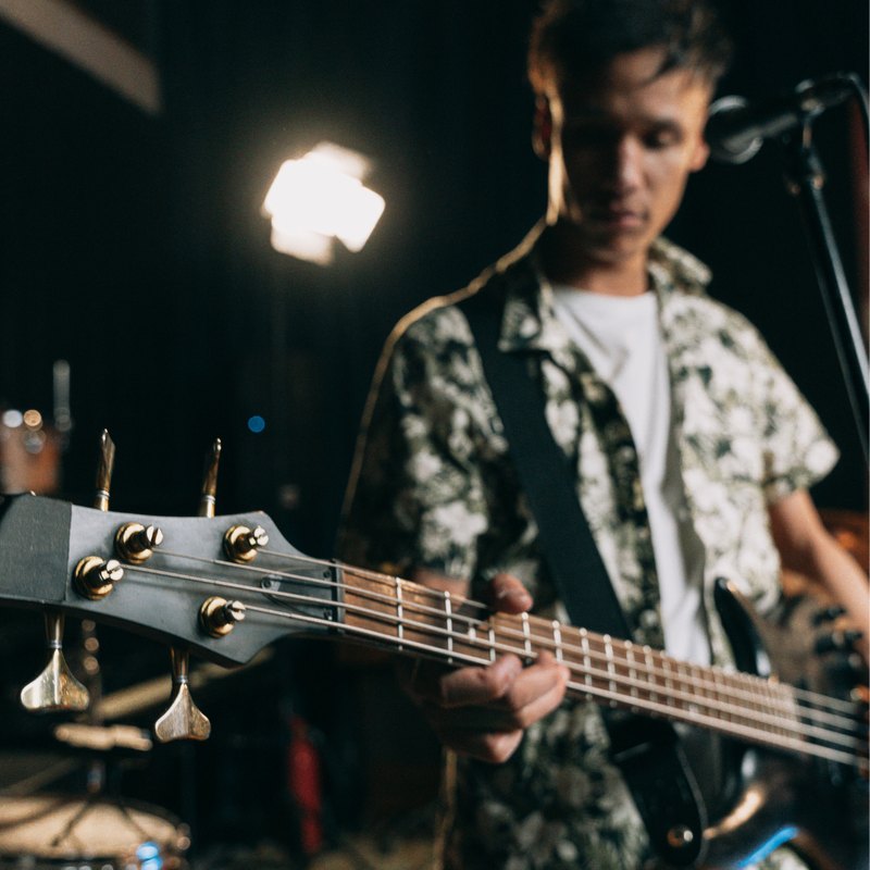 A streetwear brand founder playing bass