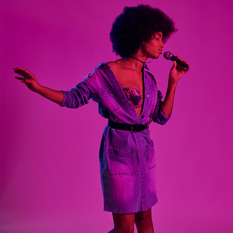 A singer performing, representing music creators